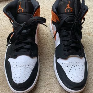 Orange, white, and black mid top Jordan 10